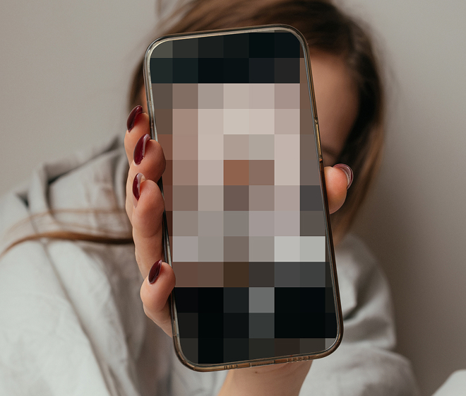 Child holding phone with pixelated screen