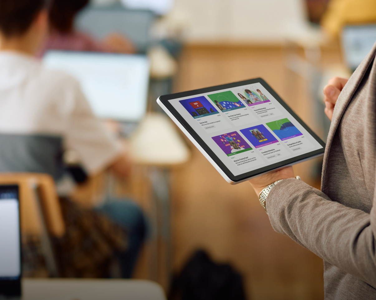 Teacher with tablet with Digital Literacy lessons on it