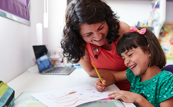 Adult and child drawing and laughing